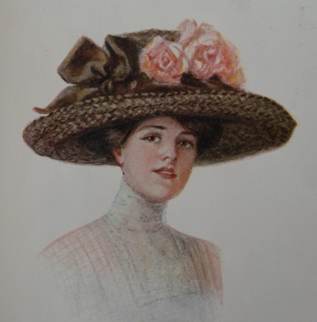 Donna di inizio Novecento con ampio cappello con rose e nastro marrone