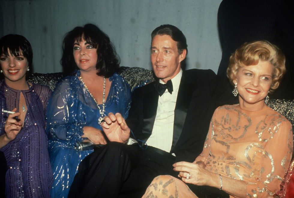 Sedute insieme allo stilista Halston, Liza Minnelli, Liz Taylor e Betty Ford indossano abiti con paillettes durante una serata allo Studio 54 nel 1979
